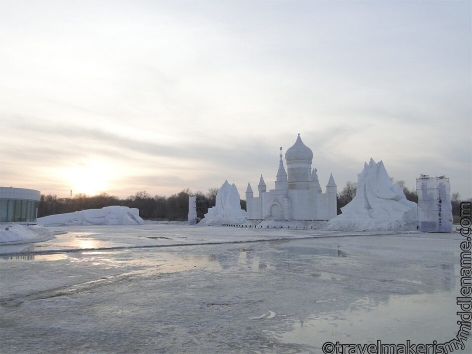 Snow sculpture modeled on the St Sophia Cathedral and the frozen lake at sunset at Sun Island