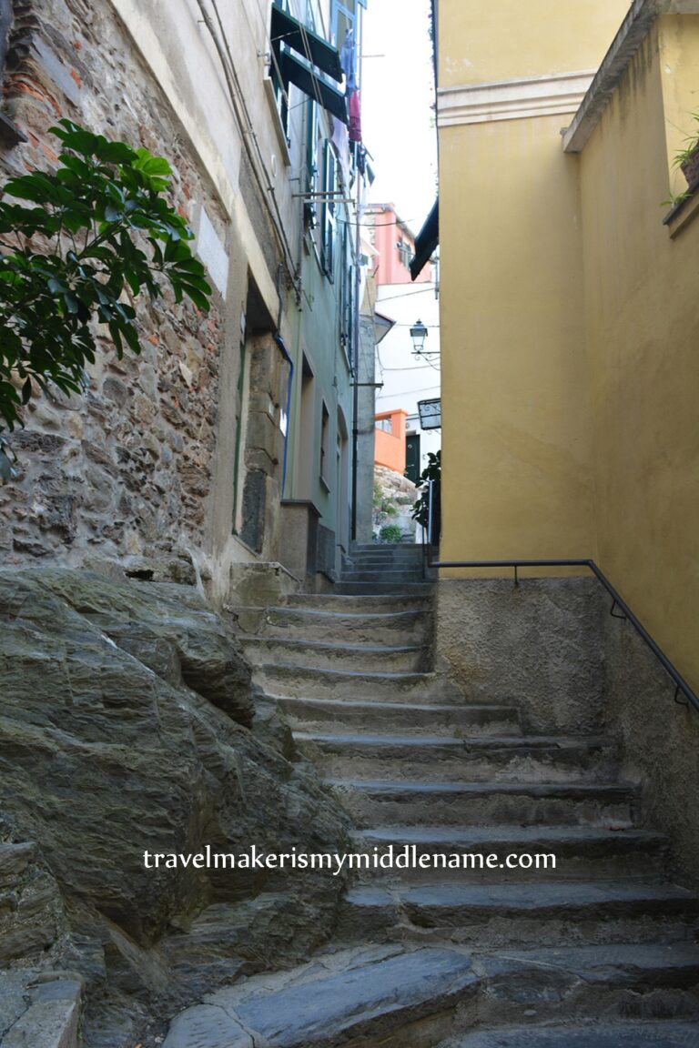 Some stone stairs in Vernazza, Cinque Terre, Italy between two buildings.