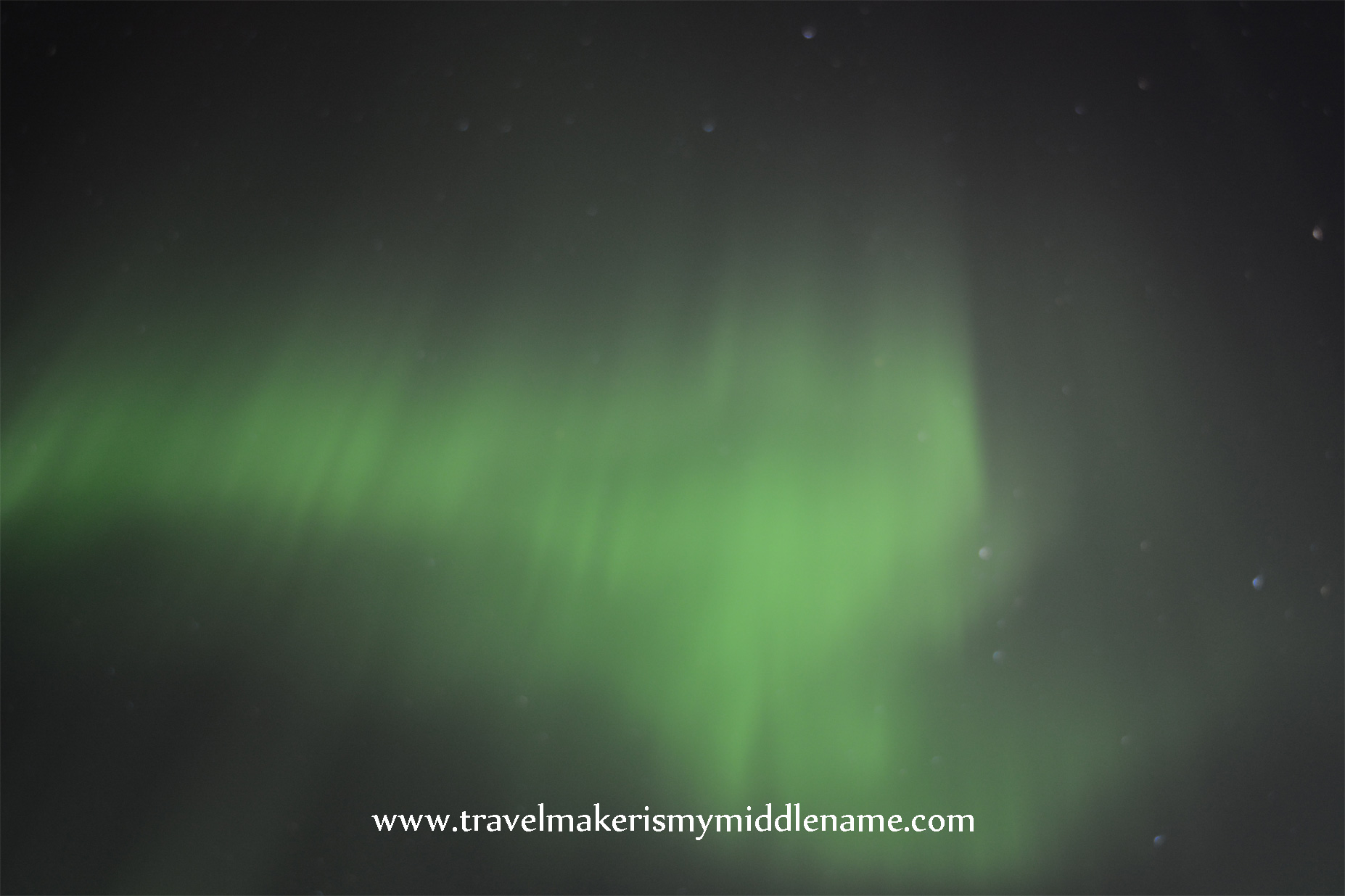 Green northern lights in the night sky