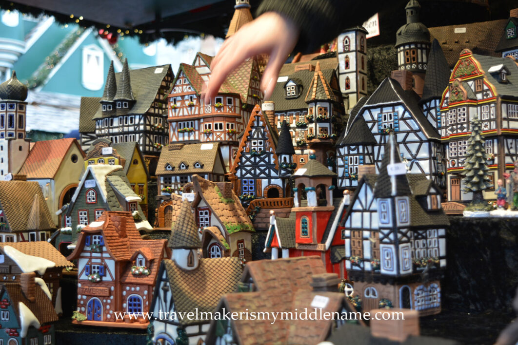 Handmade clay smoking incense houses in the form of traditional half timbered houses with a hand for scale
