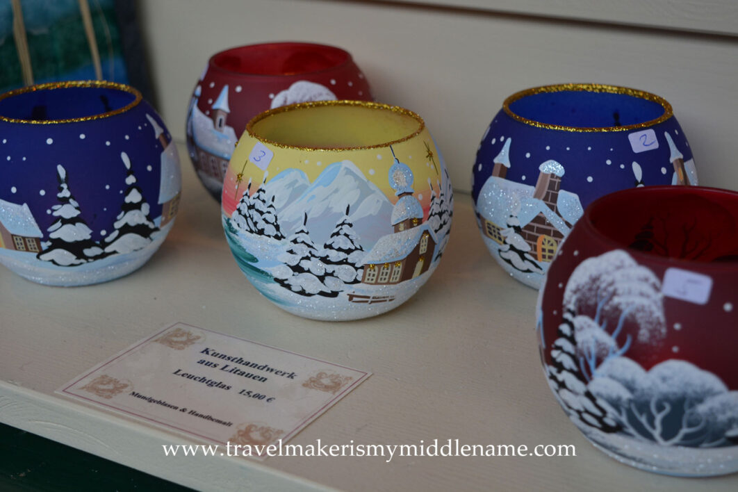 Hand painted round glass candle holders depicting snow covered towns and trees