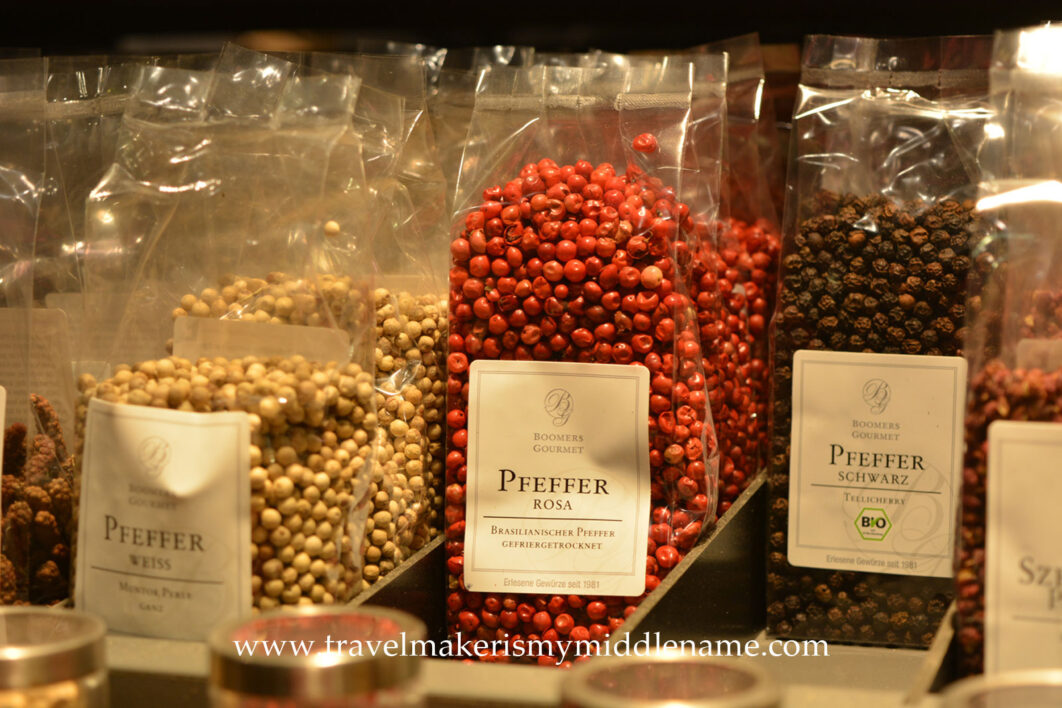 Colourful dried spices in clear plastic pouches: Left to right: white pepper, red pepper, and black pepper