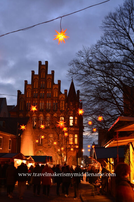 The Salt Storage building  with its jagged pointy roofline lit up at night in Lübeck