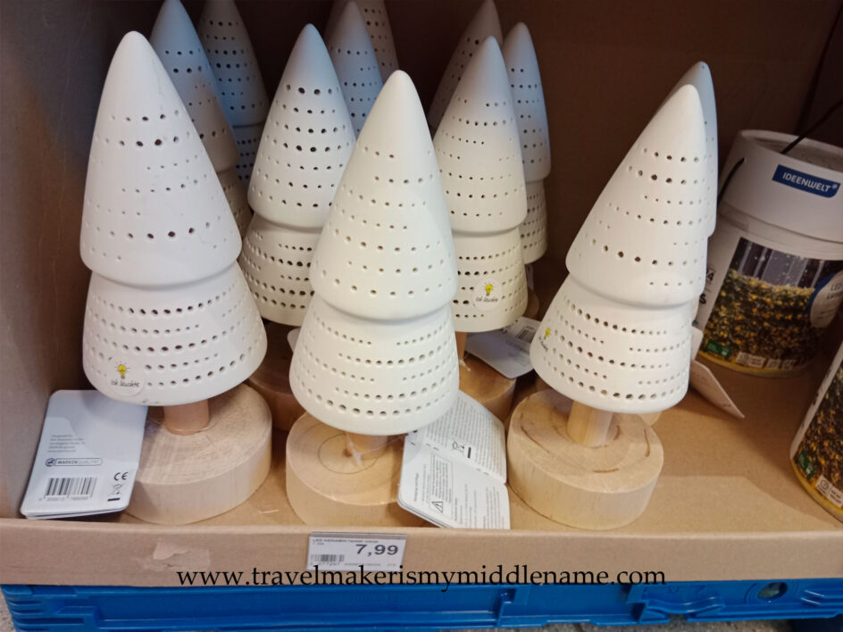 Light up battery powered LED ceramic Christmas tree ornament on a round wooden base