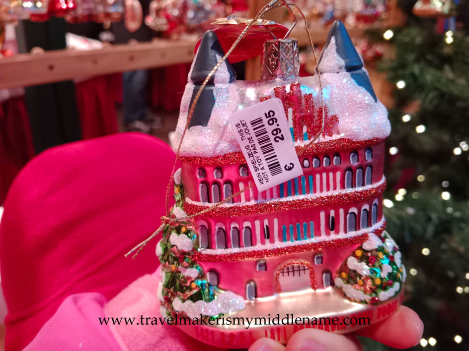 A hand blown and decorated glass bauble Christmas tree ornament in the shape of the Holstentor in Lübeck, showing a price tag of 29.95€.