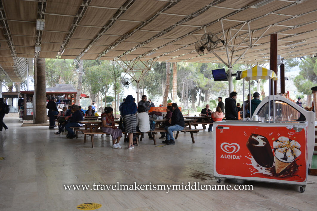 People eating in an undercover dining area in Pamukkale Antique Pool, also called Cleopatra Pool, in Pamukkale, Turkiye.
