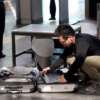 Person taking out a laptop at airport security. Photographer: Sedat Suna