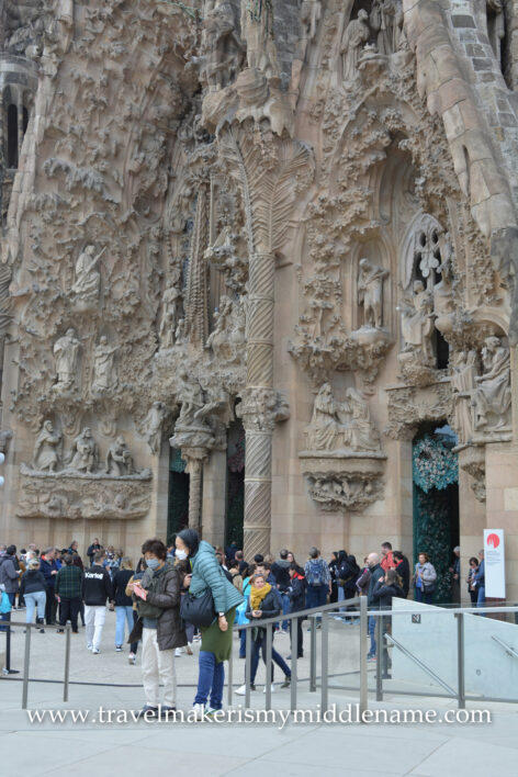 Visitors outside the facade of La Sagrada Familia church in Barcelona, Spain.