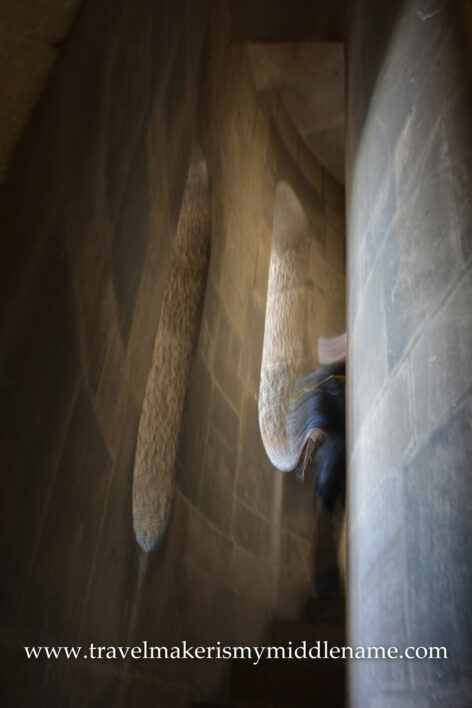 A person disappears around the curve in the narrow staircase of the Passion tower in La Sagrada Familia church in Barcelona, Spain.