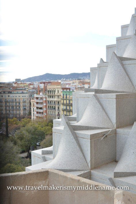 A view of the white cube and triangular prism structures forming a sloped surface on the facade of La Sagrada Familia church in Barcelona, Spain.